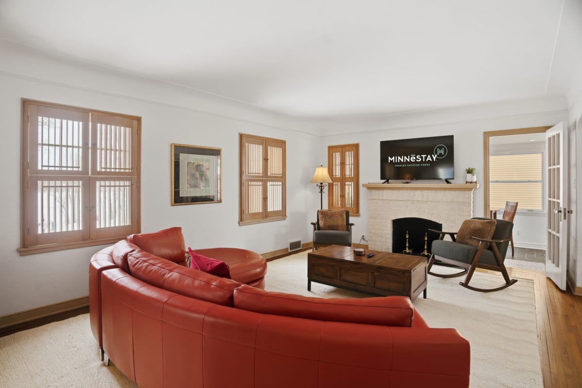 Sink into the plush leather sofa and unwind by your cozy fireplace in this bright, warmly appointed living space.