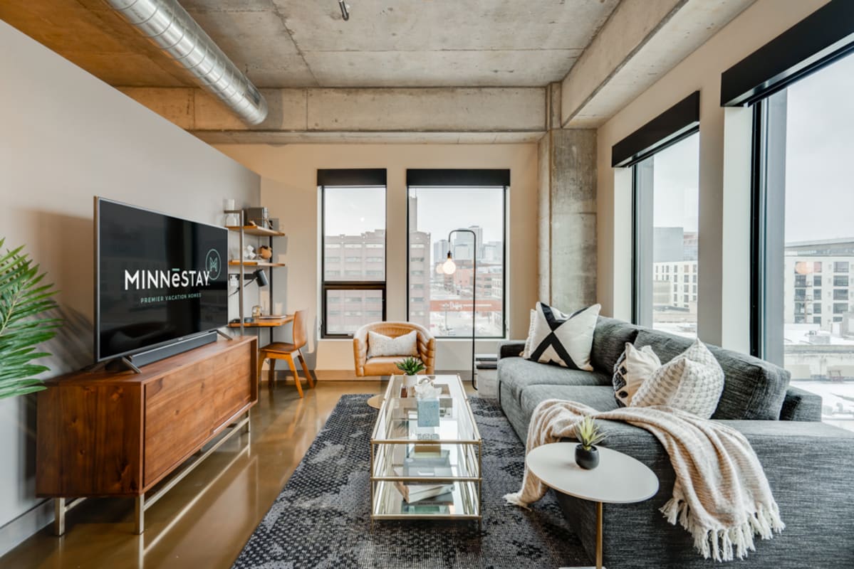 Unwind in this modern living room with plush seating, city views, and industrial touches that create your perfect urban retreat.