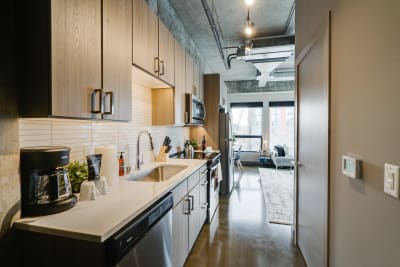 Interior view of a stylish kitchen featuring wooden cabinets and modern appliances.