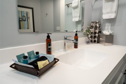 A modern bathroom vanity with toiletries and decorative elements.