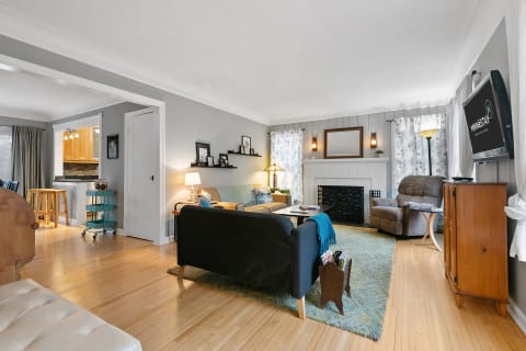 Cozy living room with a gray couch, armchair, and wooden accents.