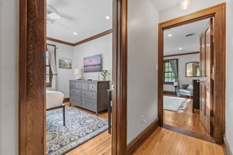 Interior view through a doorway into a stylish bedroom and adjacent living area.