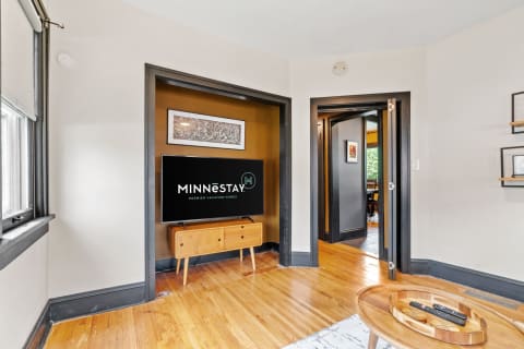 A cozy living room with a flat-screen TV and modern decor.