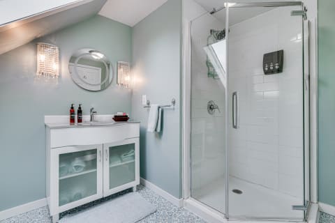 Modern bathroom with glass shower and stylish vanity.