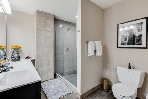 Modern bathroom with a double vanity, glass shower, and contemporary decor.