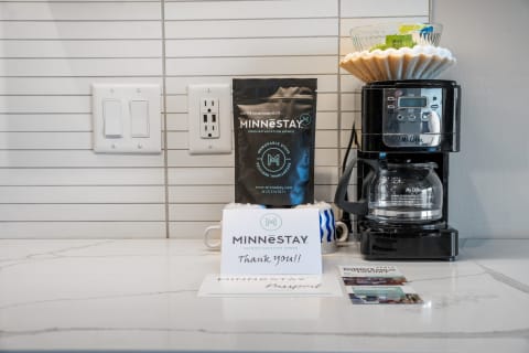 Coffee station featuring a Mr. Coffee maker, coffee filters, and a thank-you note.