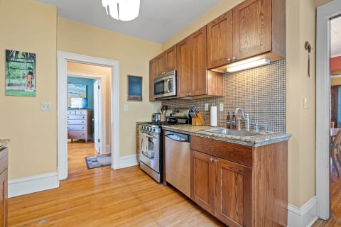 Interior of a kitchen featuring wooden cabinets and modern appliances.