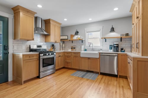 Your modern kitchen awaits with gleaming appliances, warm wood cabinets, and subway tile backsplash - perfect for preparing memorable meals together.