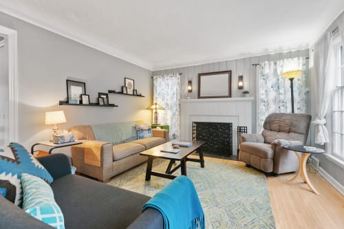 Relax in your bright living room with cozy seating, warm fireplace, and thoughtful touches that make every moment feel like home.