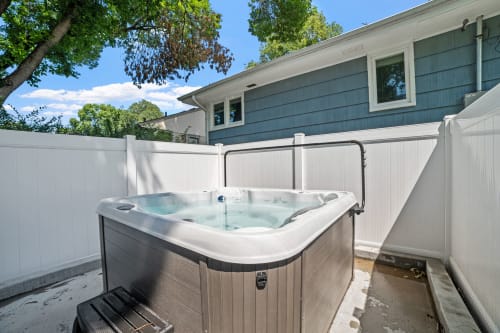 Soak away your stress in your private hot tub, perfectly nestled in a secluded courtyard for ultimate relaxation.