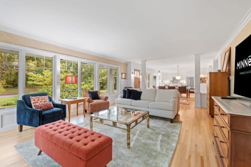 Unwind in this bright, open living space where natural light floods through expansive windows, perfect for relaxing after exploring nearby attractions.