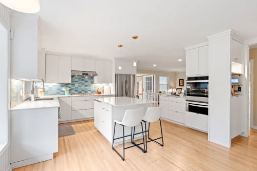 Discover your dream kitchen with sleek white cabinets, granite countertops, and modern appliances perfect for preparing memorable meals during your stay.