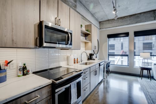 Your modern kitchen features sleek appliances and stylish finishes, perfect for preparing meals while enjoying city views.