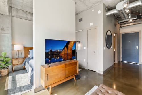 Unwind in your sleek industrial loft with polished concrete floors, exposed ceilings, and modern furnishings that create the perfect urban retreat.