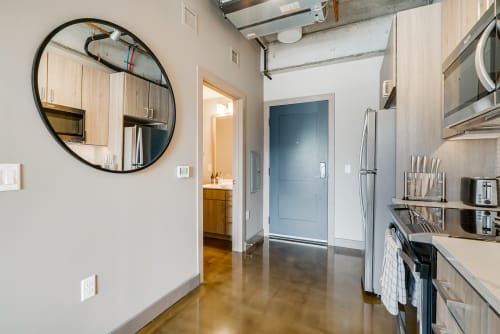 Your modern loft features sleek concrete floors, stainless appliances, and industrial charm with exposed beams overhead.