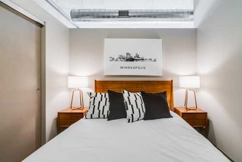Sink into this stylish bedroom with warm wood accents and soft lighting that creates the perfect atmosphere for your restful nights.