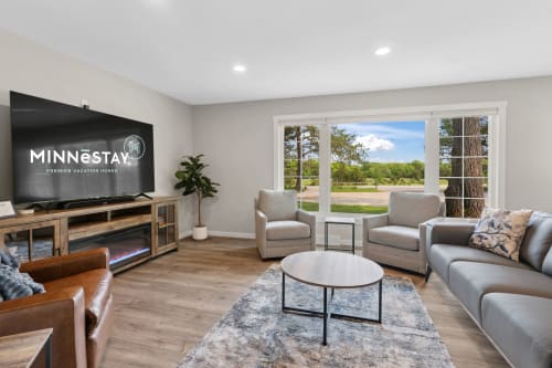 Unwind in your spacious living room with comfy seating, large TV, and beautiful nature views through the windows.