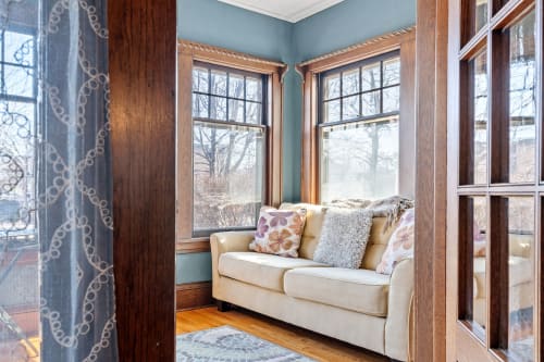 Curl up in your cozy reading nook, where soft cushions and natural light create the perfect retreat for morning coffee.