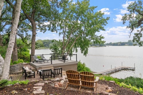 Relax on your private lakefront deck with panoramic water views, outdoor seating, and direct lake access for the perfect waterside getaway.